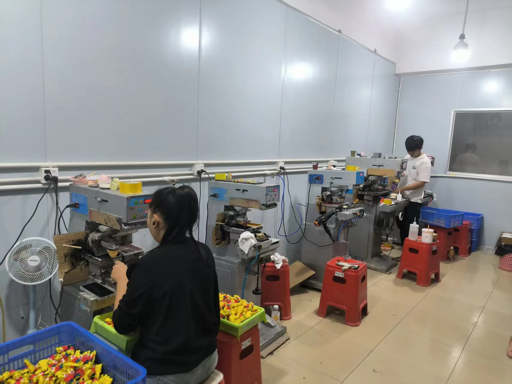 Injection moulding machines running on a production floor