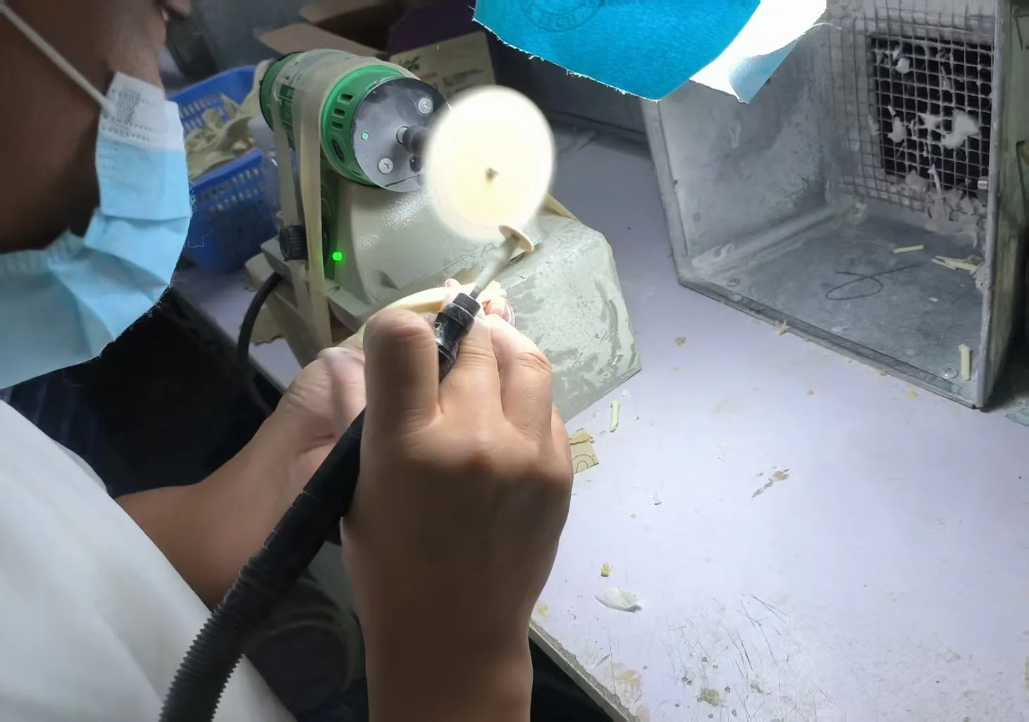 Hand-finishing a resin figure at a workbench