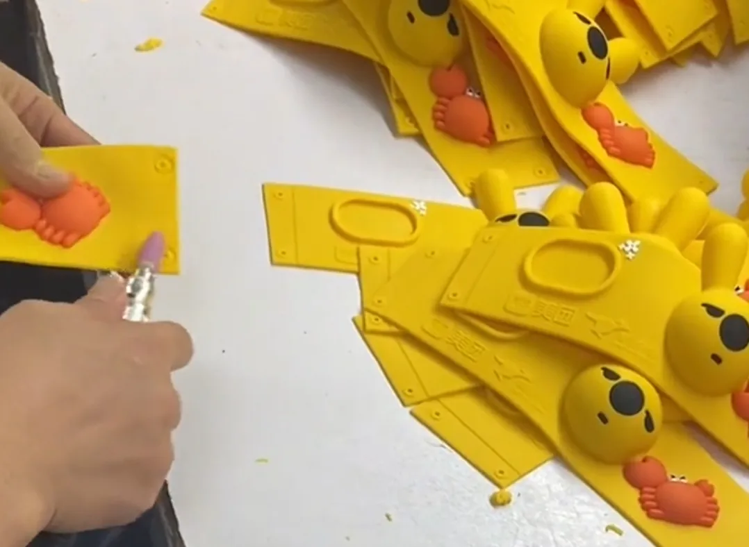 Silicone items being de-flashed by hand