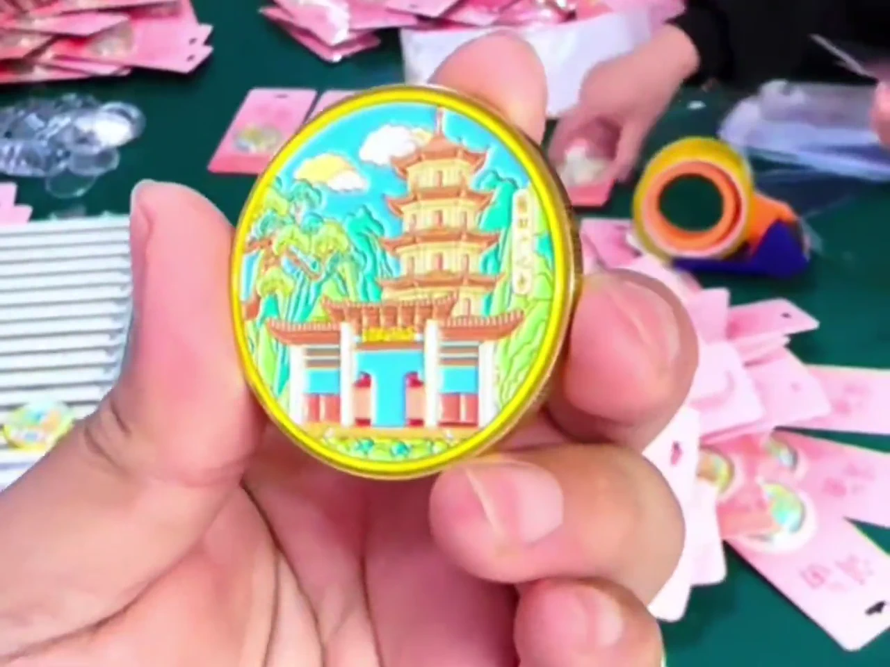 Finished zinc alloy die-cast badge held in hand